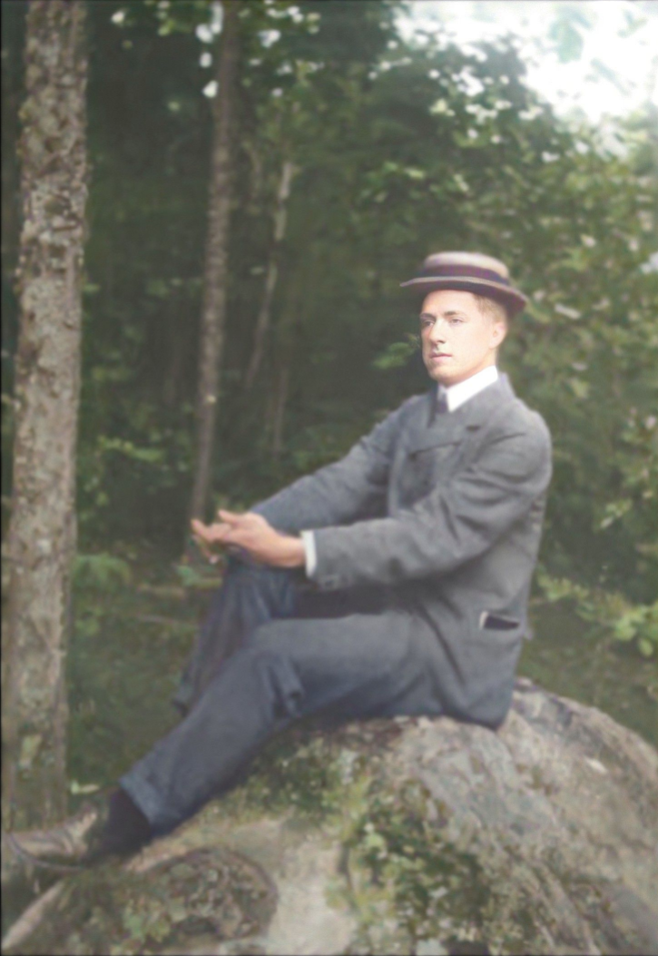 A dapper Arthur Shurcliff sitting on a rock